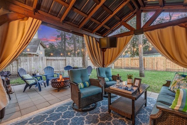 sunroom featuring a healthy amount of sunlight and vaulted ceiling with beams