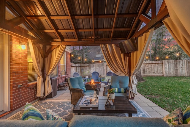 view of patio with a fenced backyard and an outdoor living space with a fire pit