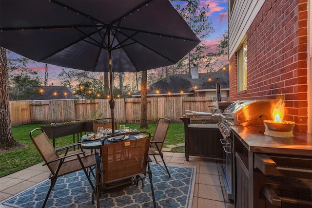 view of patio with a fenced backyard and outdoor dining area