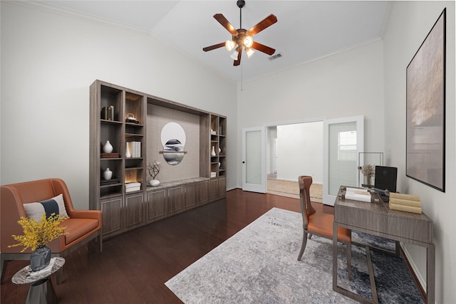 office space with dark wood-style flooring, crown molding, lofted ceiling, visible vents, and a ceiling fan