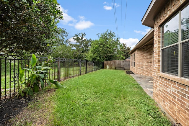 view of yard with a fenced backyard