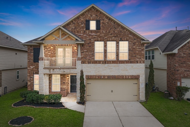 view of front facade featuring driveway, a garage, a lawn, a balcony, and brick siding