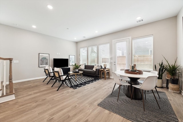 dining space with light wood finished floors, recessed lighting, visible vents, baseboards, and stairs