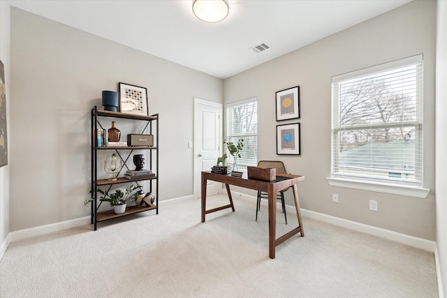 office featuring light colored carpet, visible vents, and baseboards