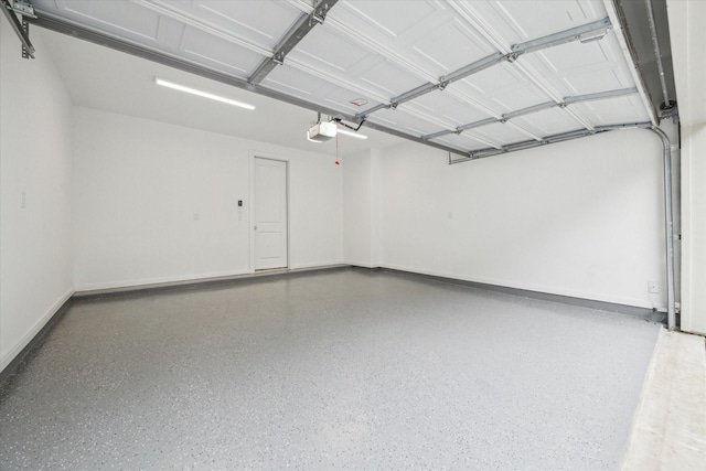 garage with baseboards and a garage door opener