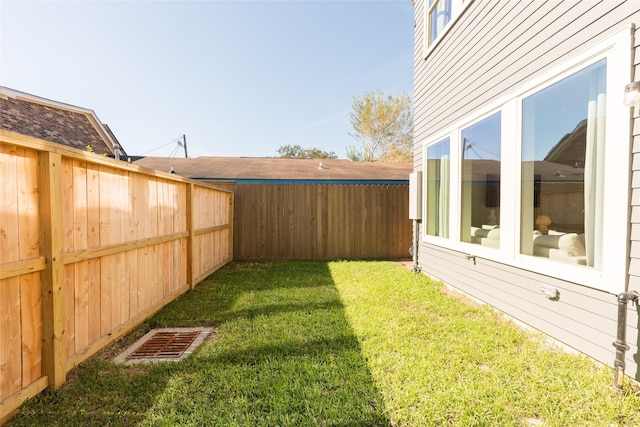 view of yard with a fenced backyard and visible vents