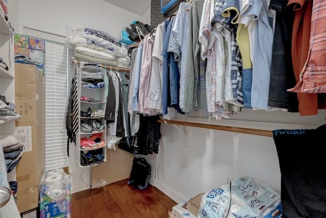 walk in closet with wood finished floors