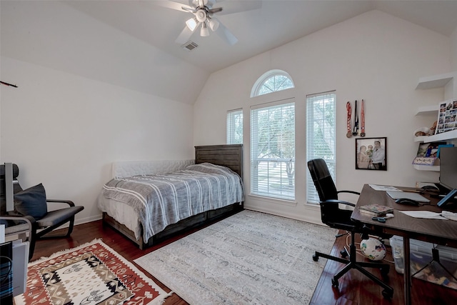 bedroom with ceiling fan, wood finished floors, visible vents, baseboards, and vaulted ceiling