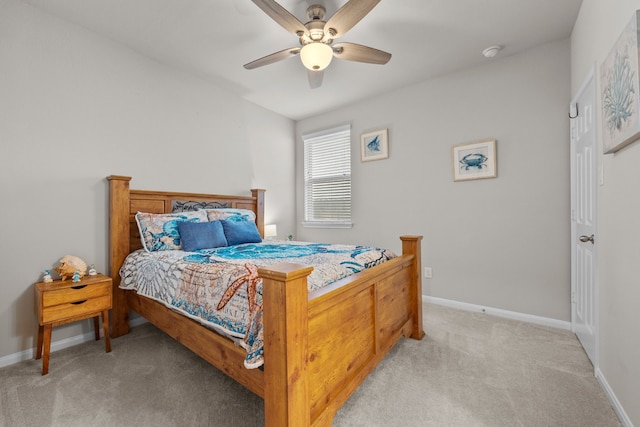 bedroom with light colored carpet, ceiling fan, and baseboards