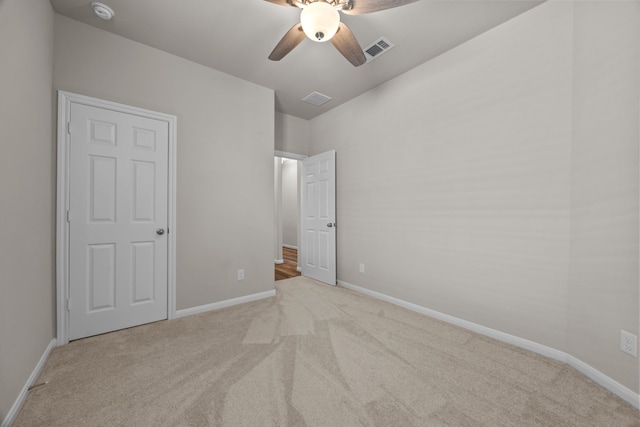 unfurnished bedroom featuring ceiling fan, carpet floors, visible vents, and baseboards