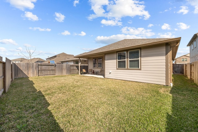 back of house with a patio area, a fenced backyard, and a yard