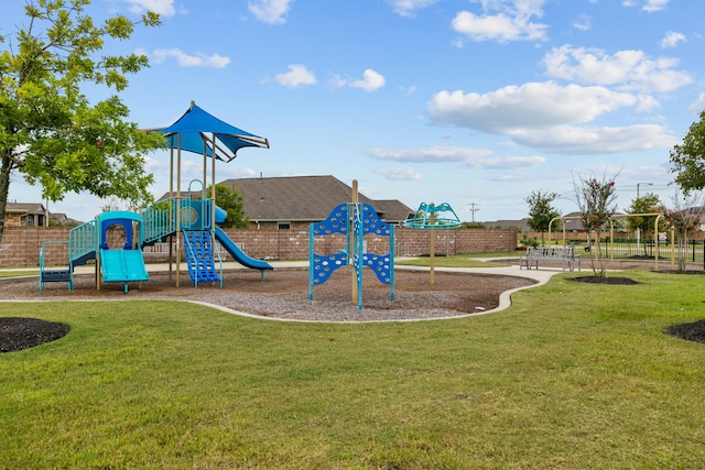 community play area with a yard and fence