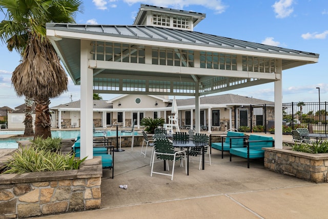 view of patio / terrace featuring fence and a community pool