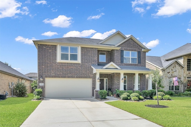 view of front facade featuring a front lawn, concrete driveway, and brick siding