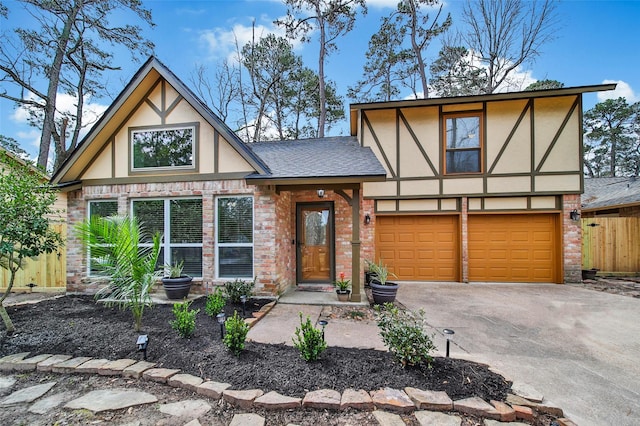 english style home featuring driveway, stucco siding, roof with shingles, an attached garage, and brick siding