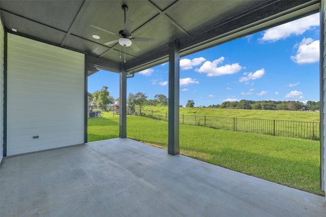 view of patio / terrace featuring a fenced backyard, ceiling fan, and a rural view