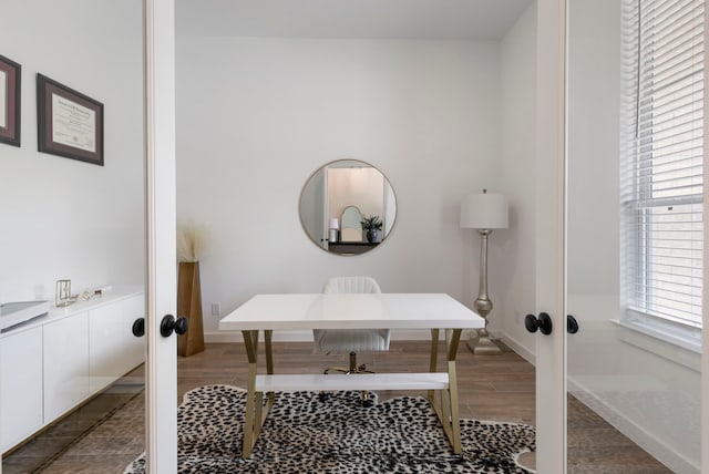 home office with baseboards, wood finished floors, and french doors