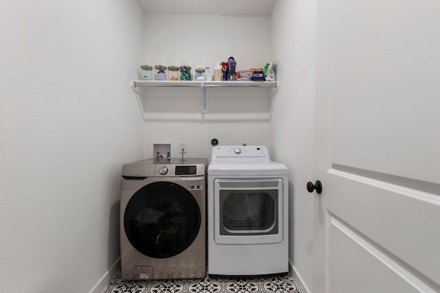 laundry area featuring laundry area, washing machine and dryer, and baseboards