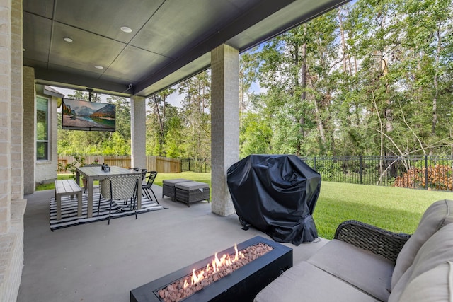 view of patio / terrace featuring outdoor dining space, an outdoor living space with a fire pit, a fenced backyard, and area for grilling