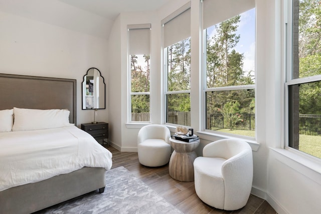 bedroom with wood finished floors and baseboards