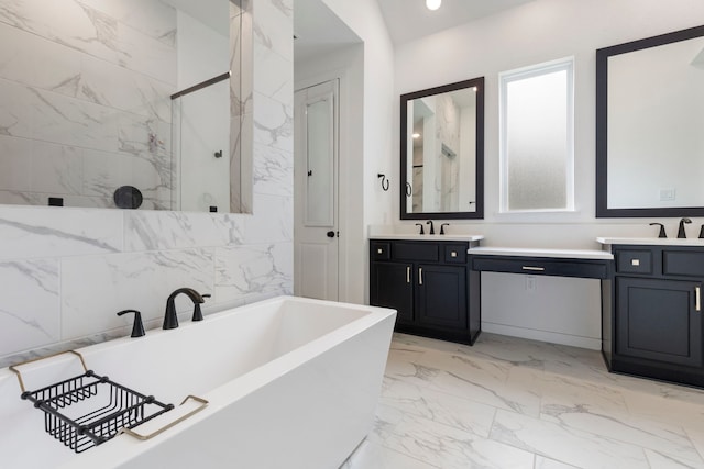 full bathroom featuring a freestanding bath, marble finish floor, vanity, and recessed lighting