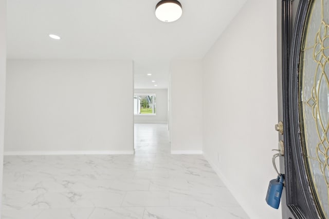 entrance foyer featuring recessed lighting, marble finish floor, and baseboards