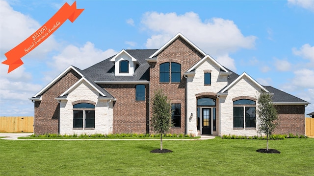 french provincial home with a front lawn, fence, brick siding, and a shingled roof