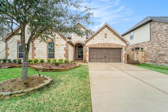 french country style house with an attached garage, fence, a front lawn, and concrete driveway