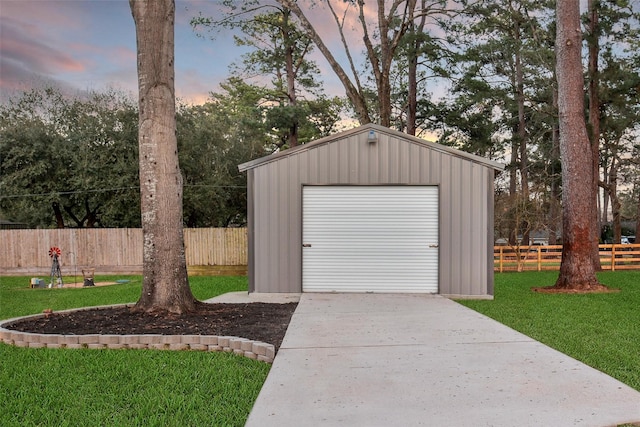 view of outbuilding with driveway, an outdoor structure, and fence