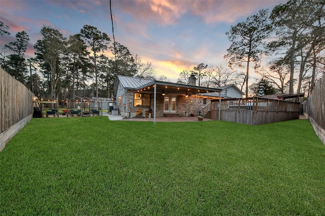 view of yard with a fenced backyard, a ceiling fan, and a patio