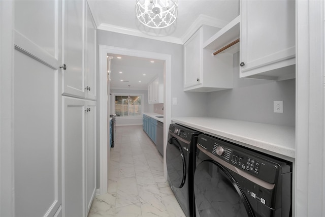 laundry room featuring ornamental molding, marble finish floor, cabinet space, and washer and clothes dryer