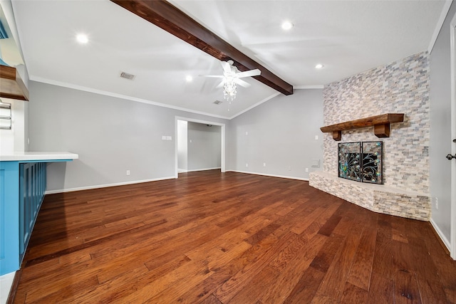 unfurnished living room featuring vaulted ceiling with beams, a stone fireplace, wood finished floors, visible vents, and a ceiling fan