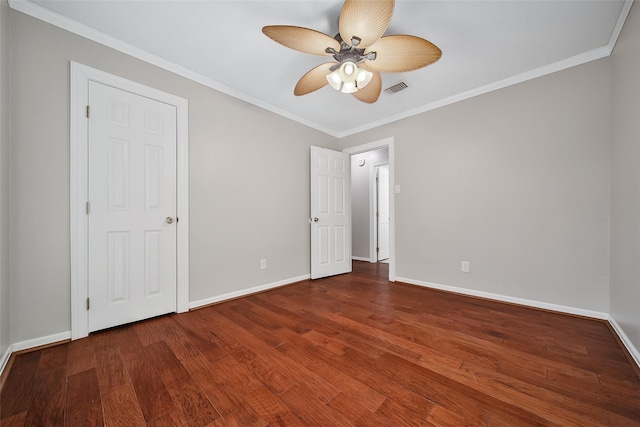 unfurnished bedroom with ornamental molding, visible vents, baseboards, and wood finished floors