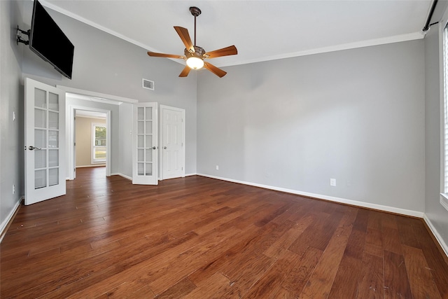 spare room featuring baseboards, visible vents, wood finished floors, and french doors