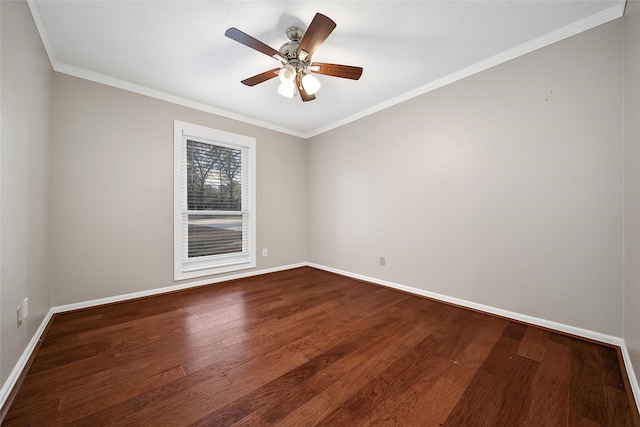 empty room featuring crown molding, ceiling fan, dark wood-style flooring, and baseboards