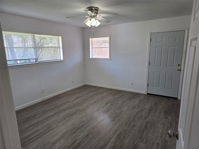 unfurnished room featuring baseboards, wood finished floors, a ceiling fan, and a healthy amount of sunlight