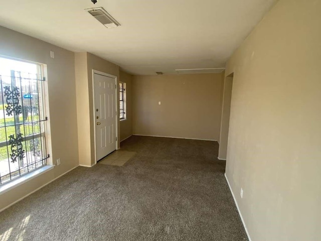 interior space with plenty of natural light, visible vents, and baseboards