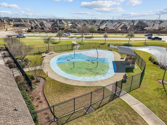 view of property's community featuring a yard, a water view, fence, and a residential view