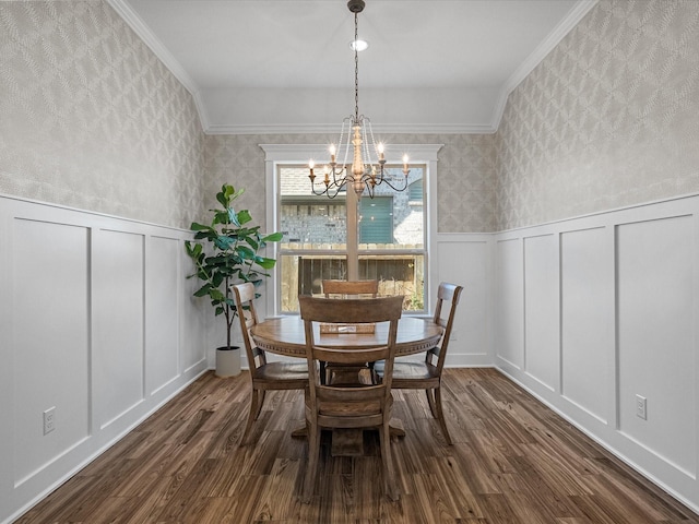 dining room featuring wainscoting, a decorative wall, and wallpapered walls