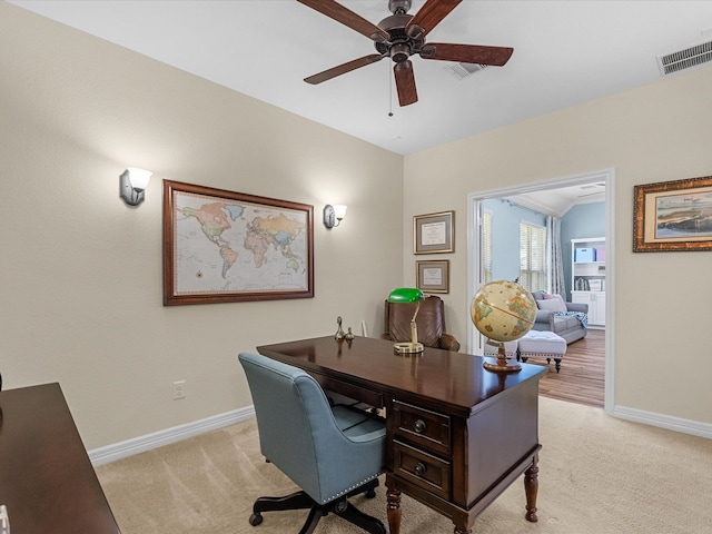 office area featuring baseboards, visible vents, and light colored carpet