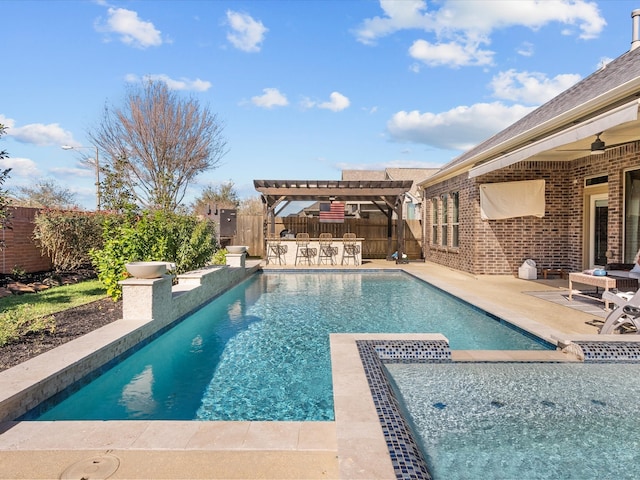 view of swimming pool featuring outdoor dry bar, a patio area, a fenced backyard, and a pergola