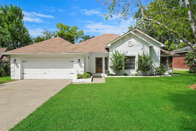 ranch-style home with an attached garage, a front yard, concrete driveway, and brick siding