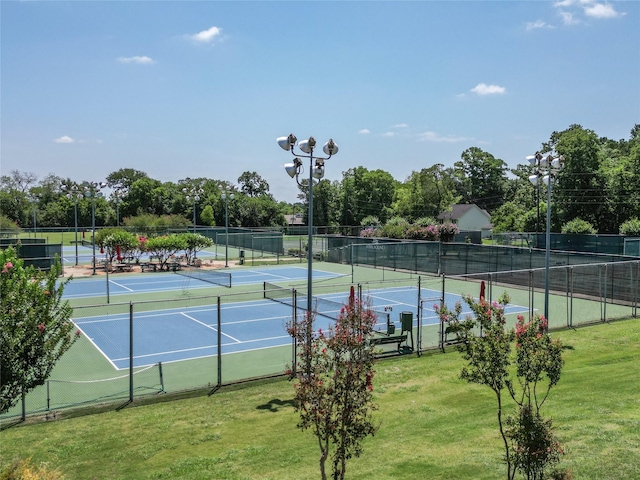 view of sport court featuring a yard and fence