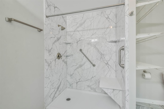 bathroom featuring marble finish floor and a marble finish shower