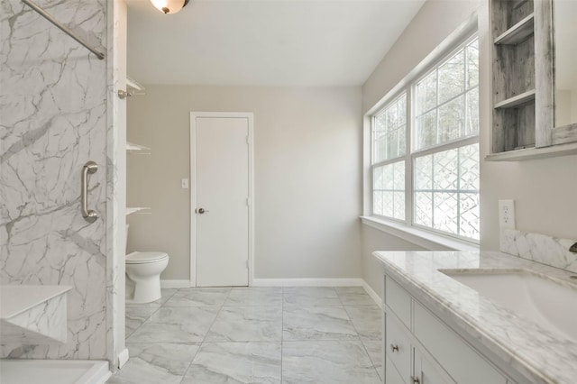 full bath with marble finish floor, a marble finish shower, toilet, vanity, and baseboards