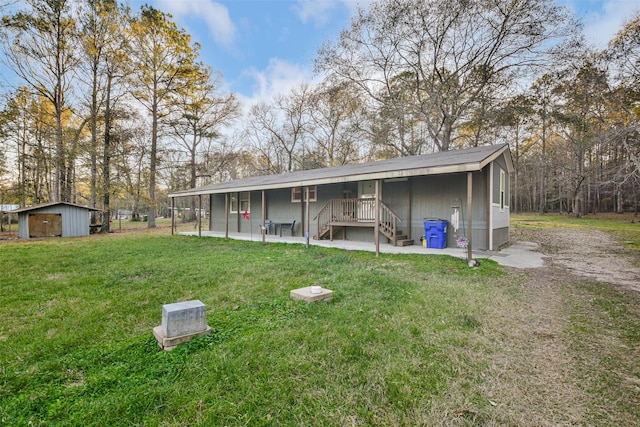 back of property with a patio area, a yard, a shed, and an outdoor structure