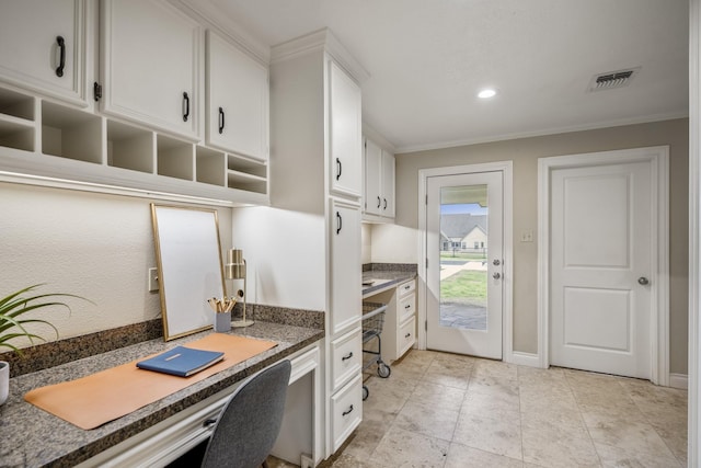 kitchen featuring visible vents, white cabinets, built in study area, ornamental molding, and recessed lighting