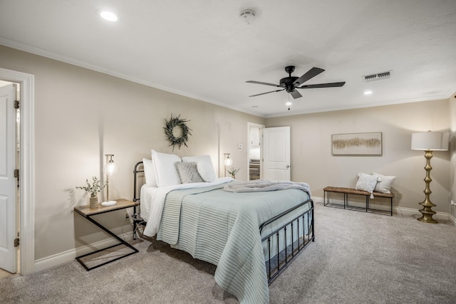 carpeted bedroom with baseboards, visible vents, and ornamental molding