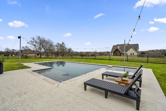 view of swimming pool featuring a fenced backyard, a lawn, and a patio