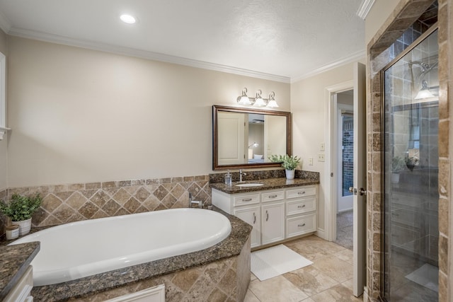 bathroom with a garden tub, vanity, tile patterned floors, a stall shower, and crown molding